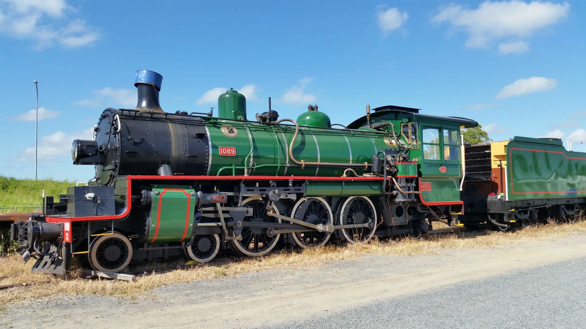 Vintage steam locomotive billowing smoke through the countryside